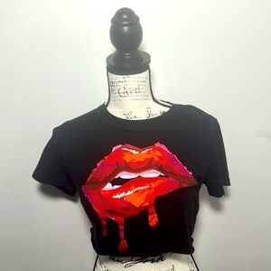 A black crop top with a big graphic design in the middle, size small